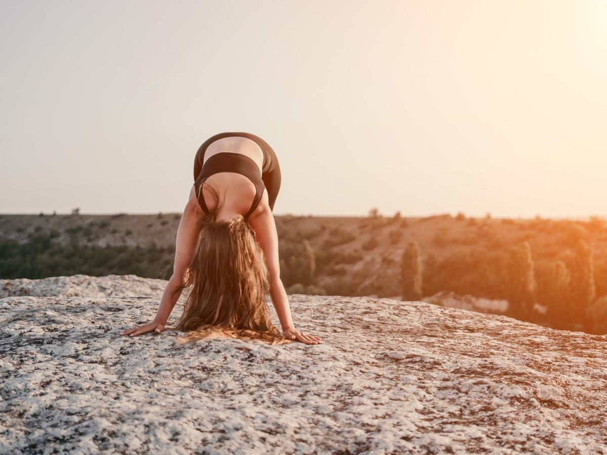 Woman stretching at sunset